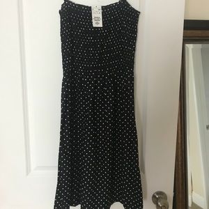Black polka-dot dress with tie straps.